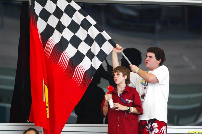 Tifosi celebrate. Saturday qualifying for the Malaysian Grand Prix. Sepang, Kuala Lumpur, Malaysia. March 20th 2004.
