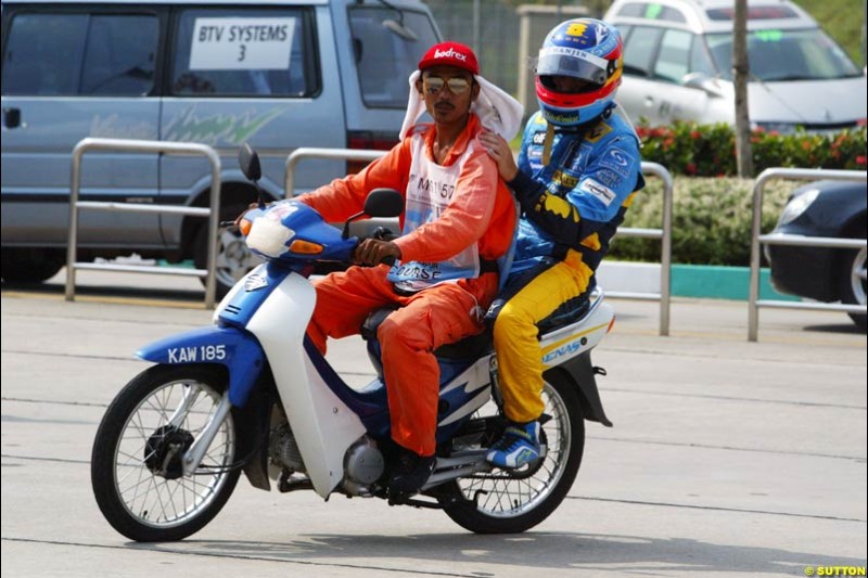 Fernando Alonso, Renault, returns to the paddock after spinning on his flying lap. Saturday qualifying for the Malaysian Grand Prix. Sepang, Kuala Lumpur, Malaysia. March 20th 2004.