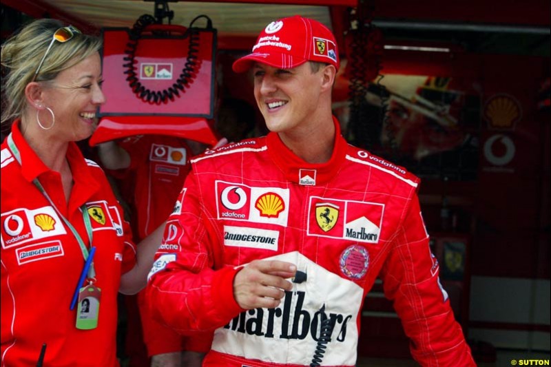 Michael Schumacher and his press officer, Sabine Kehm, after setting pole position for Ferrari. Saturday qualifying for the Malaysian Grand Prix. Sepang, Kuala Lumpur, Malaysia. March 20th 2004.