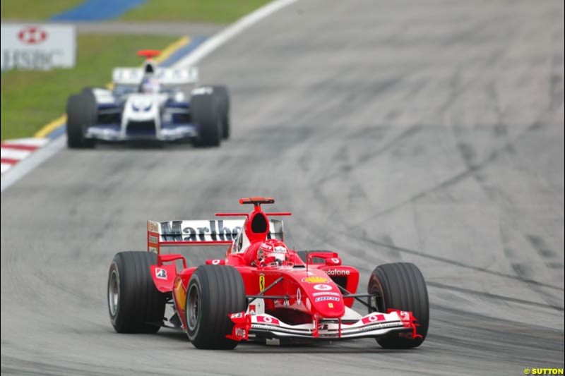 Michael Schumacher ahead of Juan Pablo Montoya. The Malaysian Grand Prix. Sepang, Kuala Lumpur, Malaysia. March 21st, 2004.