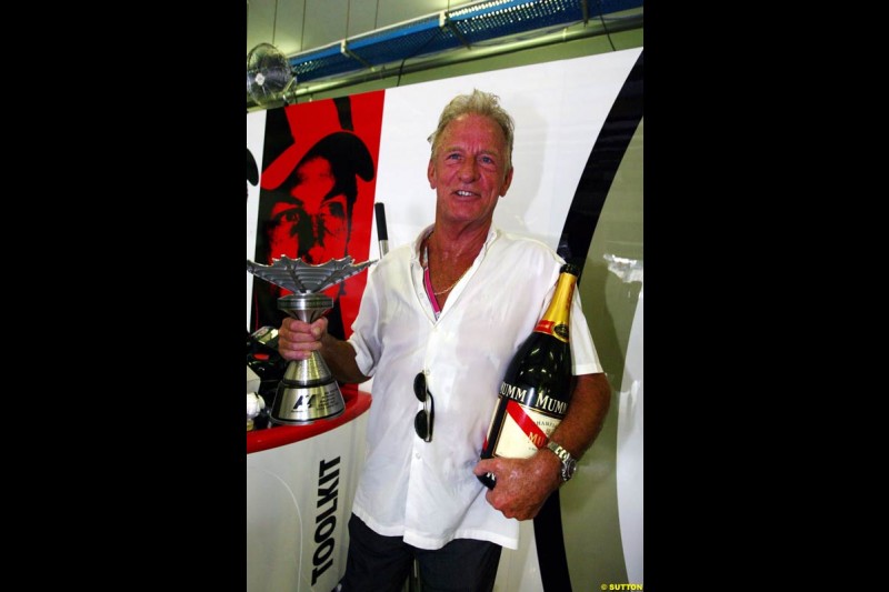 John Button holds his son Jenson's third place trophy. The Malaysian Grand Prix. Sepang, Kuala Lumpur, Malaysia. March 21st, 2004.