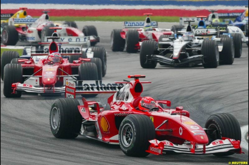 The First Lap. Michael Schumacher, Ferrari, leads the pack. The Malaysian Grand Prix. Sepang, Kuala Lumpur, Malaysia. March 21st 2004.