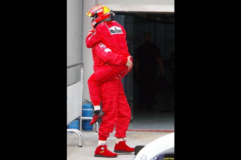 Michael Schumacher, Ferrari, embraces Ross Brawn, Ferrari Technical Director. The Malaysian Grand Prix. Sepang, Kuala Lumpur, Malaysia. March 21st 2004.