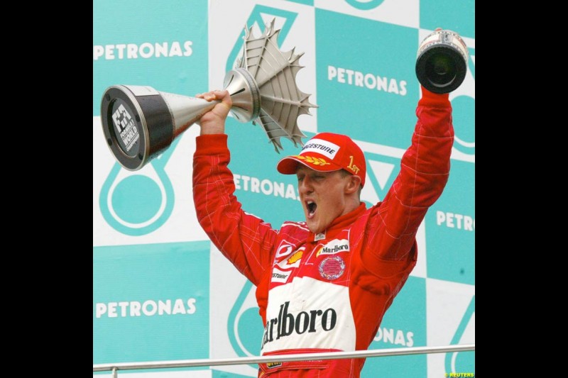 Michael Schumacher, Ferrari, celebrates victory. The Malaysian Grand Prix. Sepang, Kuala Lumpur, Malaysia. March 21st 2004.