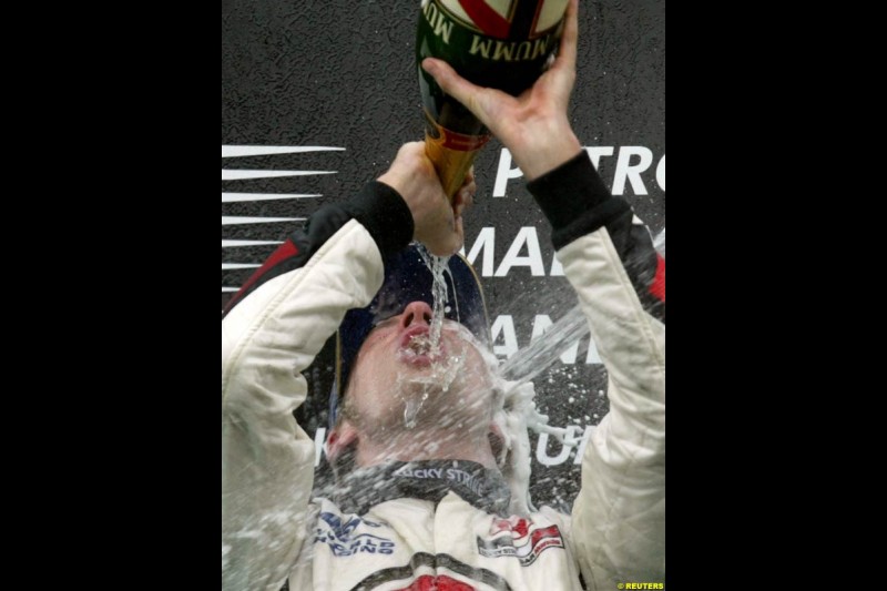 Jenson Button, BAR, celebrates third place. The Malaysian Grand Prix. Sepang, Kuala Lumpur, Malaysia. March 21st 2004.