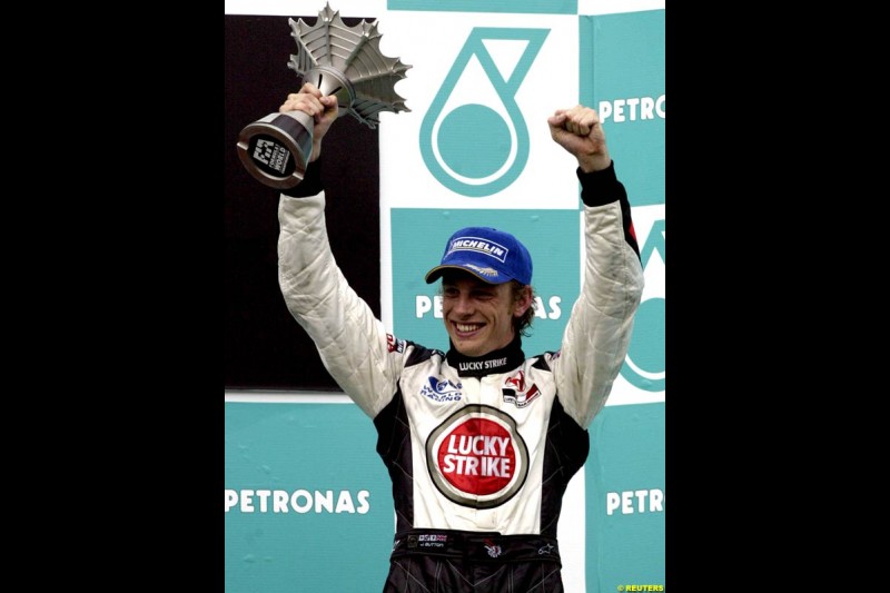 Jenson Button, BAR, celebrates third place. The Malaysian Grand Prix. Sepang, Kuala Lumpur, Malaysia. March 21st 2004.