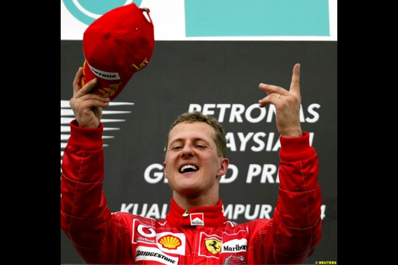 Michael Schumacher, Ferrari, celebrates victory. The Malaysian Grand Prix. Sepang, Kuala Lumpur, Malaysia. March 21st 2004.