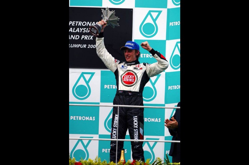 Jenson Button, BAR, celebrates third place. The Malaysian Grand Prix. Sepang, Kuala Lumpur, Malaysia. March 21st 2004.