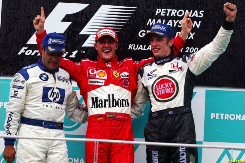 The Podium celebrations. 1st, Michael Schumacher, Ferrari; 2nd, Juan Pablo Montoya, Williams; 3rd, Jenson Button, BAR. The Malaysian Grand Prix. Sepang, Kuala Lumpur, Malaysia. March 21st 2004.