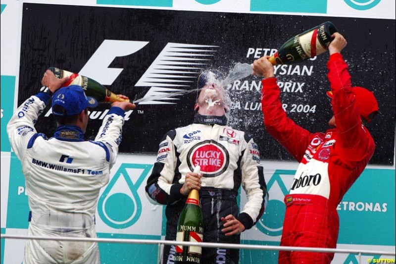 The Podium celebrations. 1st, Michael Schumacher, Ferrari; 2nd, Juan Pablo Montoya, Williams; 3rd, Jenson Button, BAR. The Malaysian Grand Prix. Sepang, Kuala Lumpur, Malaysia. March 21st 2004.