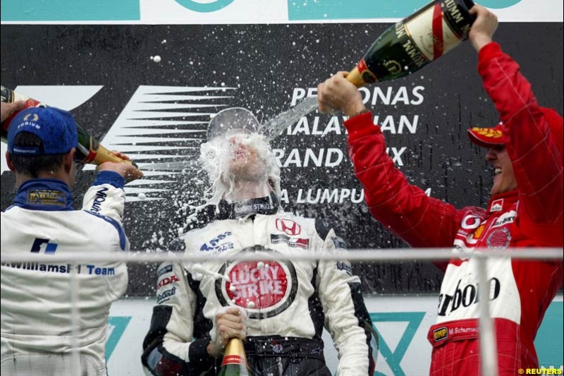 The Podium celebrations. 1st, Michael Schumacher, Ferrari; 2nd, Juan Pablo Montoya, Williams; 3rd, Jenson Button, BAR. The Malaysian Grand Prix. Sepang, Kuala Lumpur, Malaysia. March 21st 2004.