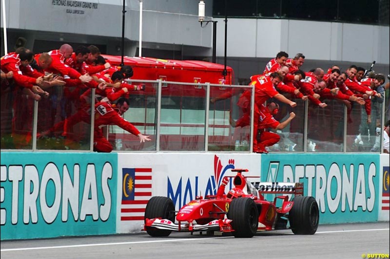 Michael Schumacher, Ferrari, celebrates victory. The Malaysian Grand Prix. Sepang, Kuala Lumpur, Malaysia. March 21st 2004.