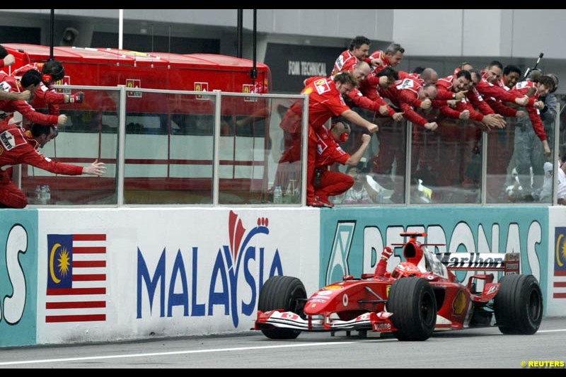 Michael Schumacher, Ferrari, celebrates victory. The Malaysian Grand Prix. Sepang, Kuala Lumpur, Malaysia. March 21st 2004.