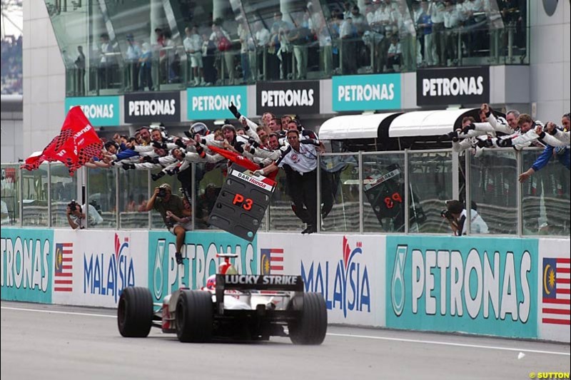 Jenson Button, BAR, crosses the line to take third place. The Malaysian Grand Prix. Sepang, Kuala Lumpur, Malaysia. March 21st 2004.