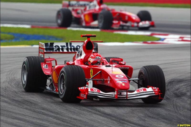 Michael Schumacher, Ferrari, leads from team mate Rubens Barrichello. The Malaysian Grand Prix. Sepang, Kuala Lumpur, Malaysia. March 21st 2004.