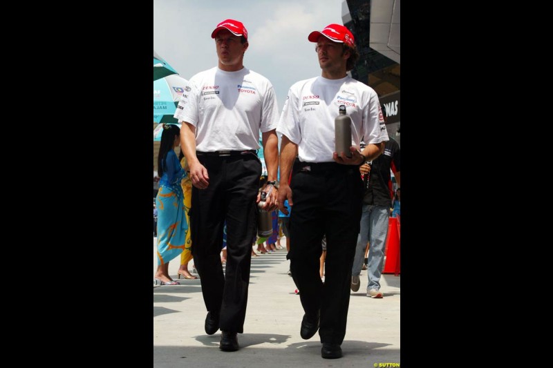 Olivier Panis and Cristiano da Matta, Toyota, at the drivers parade. The Malaysian Grand Prix. Sepang, Kuala Lumpur, Malaysia. March 21st 2004.