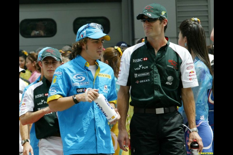 Fernando Alonso and Mark Webber at the drivers parade. The Malaysian Grand Prix. Sepang, Kuala Lumpur, Malaysia. March 21st 2004. 
