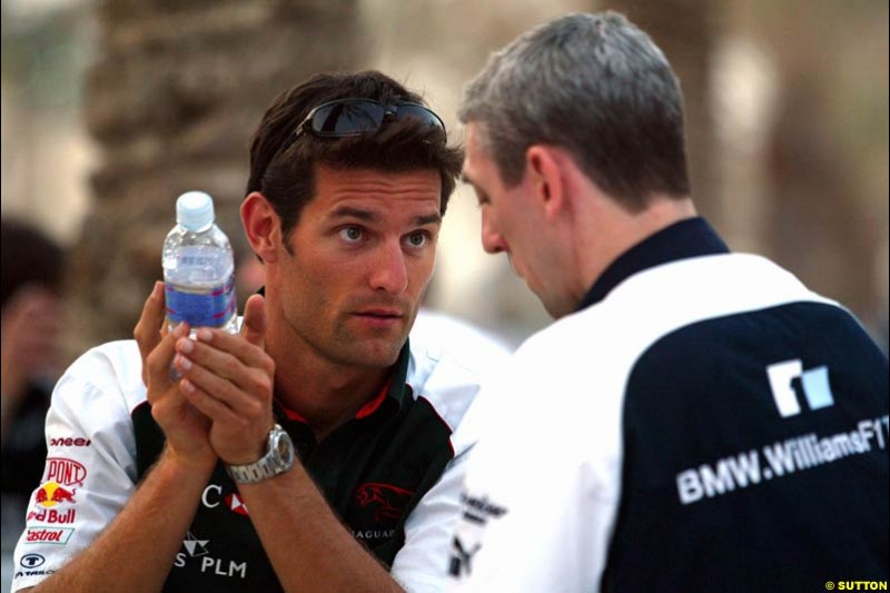 Mark Webber with Williams's commercial director Jim Wright. Has the Jaguar driver and the Williams team reached a deal for next season on this occasion? Bahrain Grand Prix, Bahrain International Circuit. April 1st, 2004.
