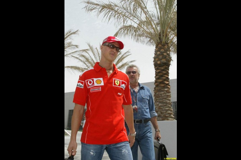 Michael Schumacher and Willi Weber arrive at the circuit. Bahrain Grand Prix, Bahrain International Circuit. April 1st, 2004.