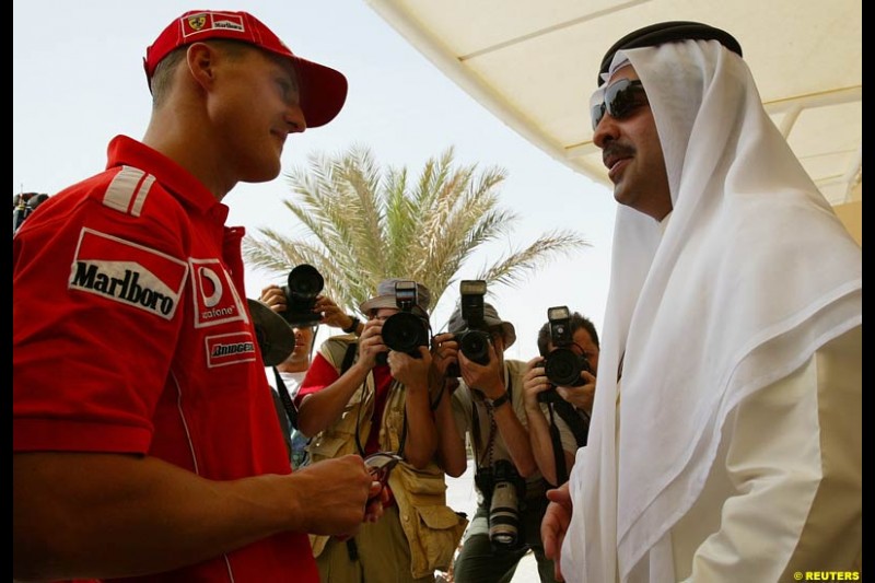 Michael Schumacher talks to Shaik Fawaz Bin Mohammed Al Khalifa, chairman of the Bahrain International Circuit. Bahrain Grand Prix, Bahrain International Circuit. April 1st, 2004.