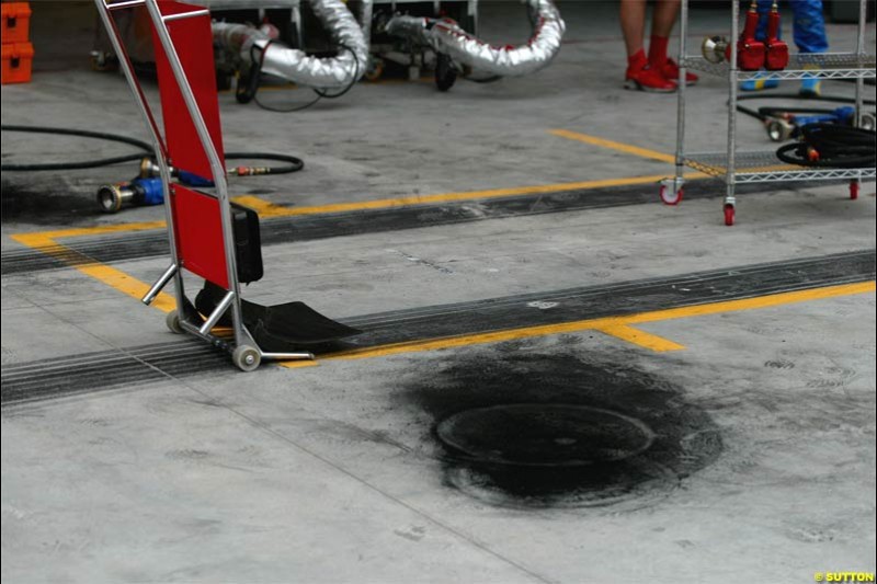 Brake carbon dust on the Ferrari pit area. The Bahrain Grand Prix. Bahrain International Circuit, April 4th 2004.