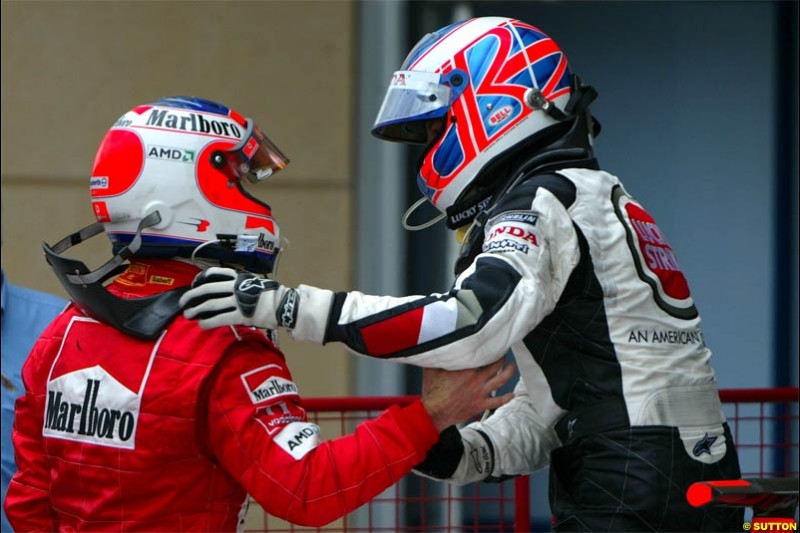 Jenson Button, BAR, together with Rubens Barrichello, Ferrari. The Bahrain Grand Prix. Bahrain International Circuit, April 4th 2004.