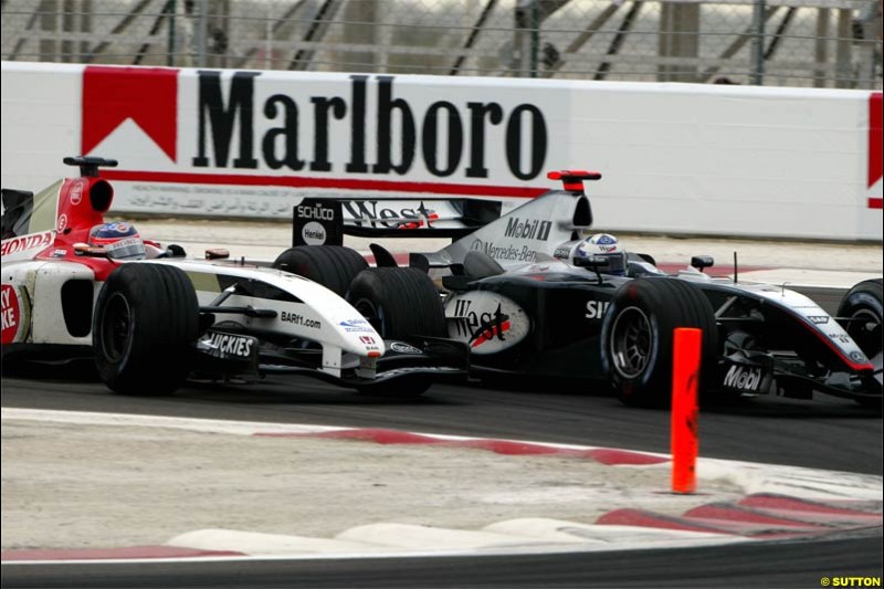 Takuma Sato, BAR, fights with David Coulthard, McLaren. The Bahrain Grand Prix. Bahrain International Circuit, April 4th 2004.