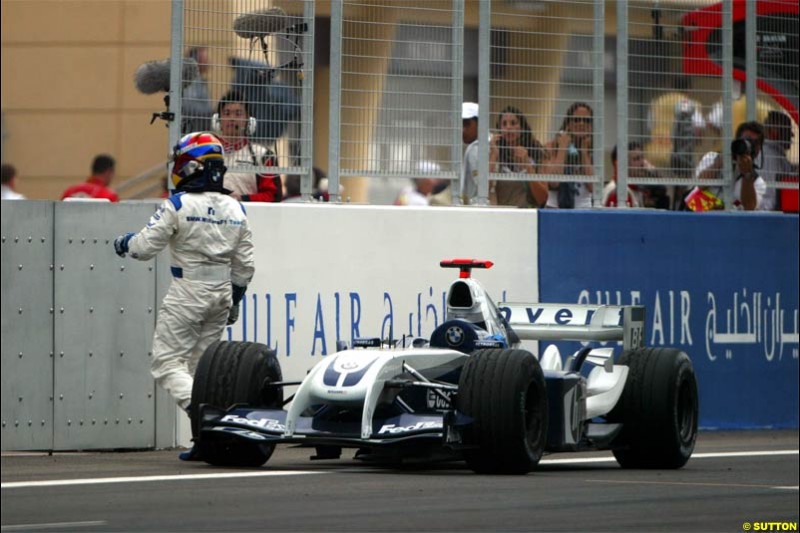 Juan Pablo Montoya, Williams, steps out of his car after retiring. The Bahrain Grand Prix. Bahrain International Circuit, April 4th 2004.