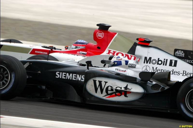David Coulthard, McLaren, and Takuma Sato, BAR, battle for position. The Bahrain Grand Prix. Bahrain International Circuit, April 4th 2004.