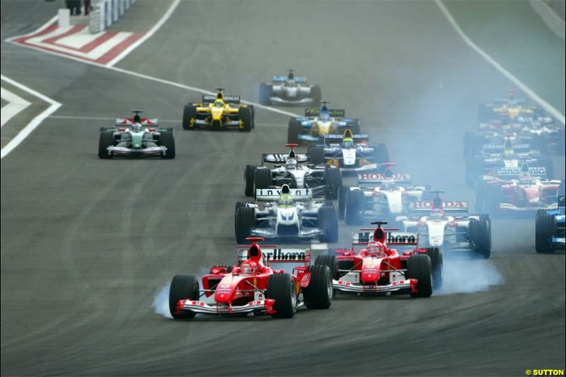 Michael Schumacher, Ferrari, locks a wheel due to cold tyres. The Bahrain Grand Prix. Bahrain International Circuit, April 4th 2004.
