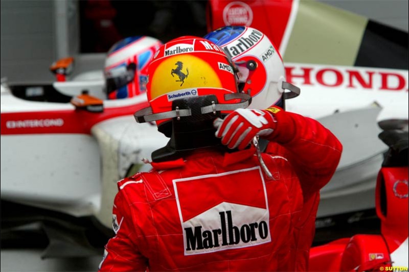 Michael Schumacher, Ferrari, and Rubens Barrichello, Ferrari, exchange congratulations. The Bahrain Grand Prix. Bahrain International Circuit, April 4th 2004.