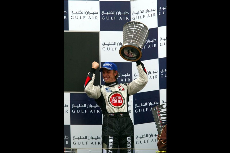 Jenson Button, BAR, celebrates third place. The Bahrain Grand Prix. Bahrain International Circuit, April 4th 2004.