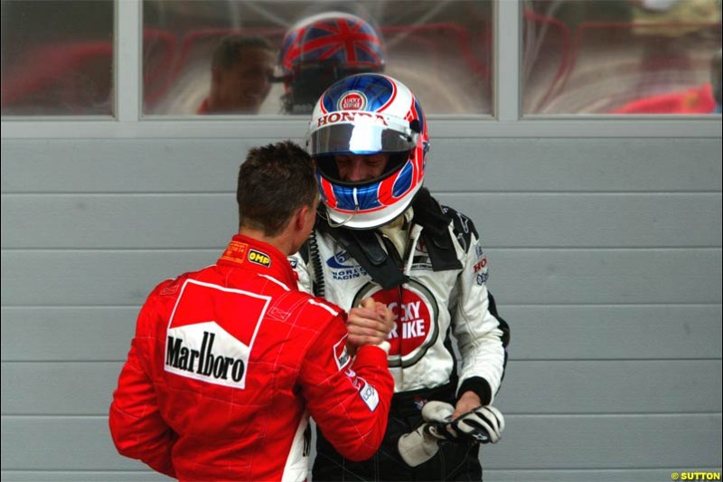 Michael Schumacher, Ferrari, and Jenson Button, BAR, exchange congratulations. The Bahrain Grand Prix. Bahrain International Circuit, April 4th 2004.