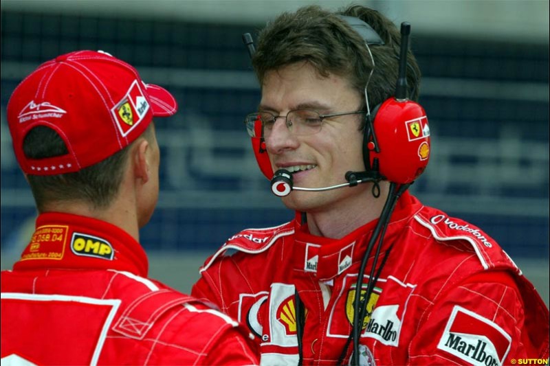 Michael Schumacher, Ferrari, talks to Chris Dyer, Ferrari Race Engineer. The Bahrain Grand Prix. Bahrain International Circuit, April 4th 2004.