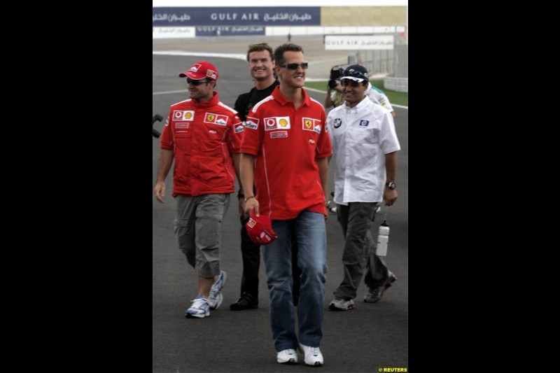 Michael Schumacher, Ferrari, walks with Juan Pablo Montoya, Williams, David Coulthard, McLaren, and Rubens Barrichello, Ferrari. The Bahrain Grand Prix. Bahrain International Circuit, April 4th 2004.