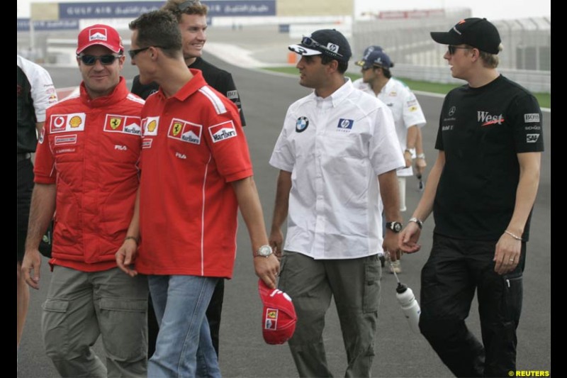 Michael Schumacher, Ferrari, walks with Juan Pablo Montoya, Williams, Kimi Raikkonen, McLaren, and Rubens Barrichello, Ferrari. The Bahrain Grand Prix. Bahrain International Circuit, April 4th 2004.