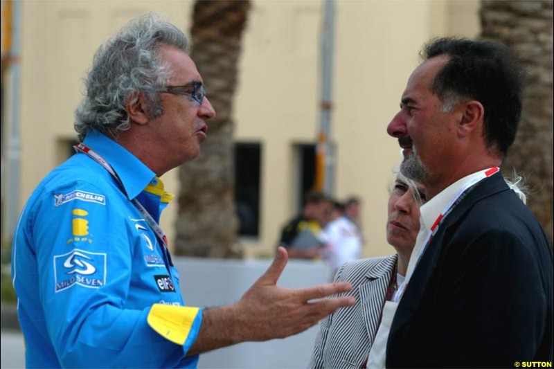 Flavio Briatore, Renault Team Principle, chats to Bernd Pietschrieder, Boss of VW. Race Day for the Bahrain Grand Prix. Bahrain International Circuit, April 4th 2004.