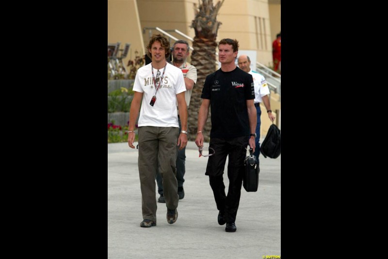 David Coulthard, McLaren, with Jenson Button, BAR. Race Day for the Bahrain Grand Prix. Bahrain International Circuit, April 4th 2004.
