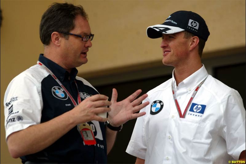 Ralf Schumacher, Williams, talks to Frank Dernie, Williams Head of Special Projects. Race Day for the Bahrain Grand Prix. Bahrain International Circuit, April 4th 2004.
