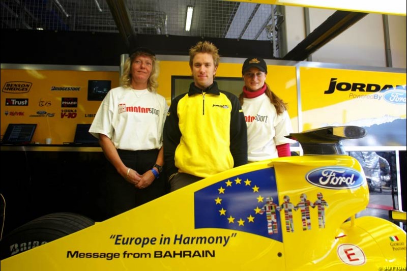(L to R): Nick Heidfeld (GER) with the prize winning designers of the livery for the Message from Bahrain for this race, which is Europe in Harmony. Formula One World Championship, Rd 7, European Grand Prix, Nurburgring, Germany, Practice, 28 May 2004.