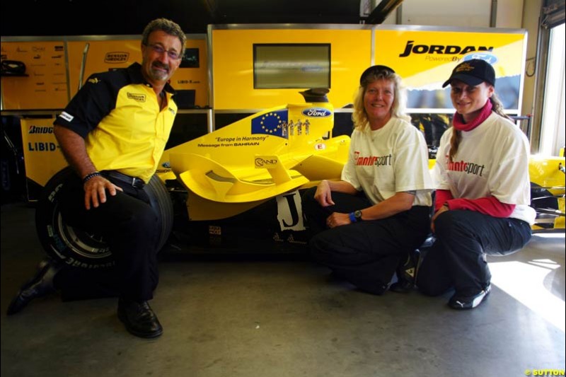 (L to R): Eddie Jordan (IRE) Jordan Team Owner with the prize winning designers of the livery for the Message from Bahrain for this race, which is Europe in Harmony. Formula One World Championship, Rd 7, European Grand Prix, Nurburgring, Germany, Practice, 28 May 2004.