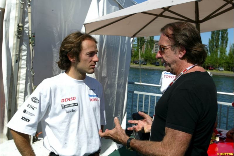 Toyota driver Cristiano da Matta chats with former World Champion Emerson Fittipaldi. The Canadian Grand Prix, Montreal, Canada. Saturday, June 13th, 2004.