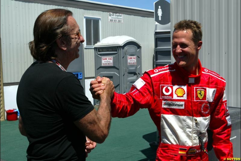 Former World Champion Emerson Fittipaldi and Michael Schumacher, Ferrari, after qualifying. The Canadian Grand Prix, Montreal, Canada. Saturday, June 13th, 2004.