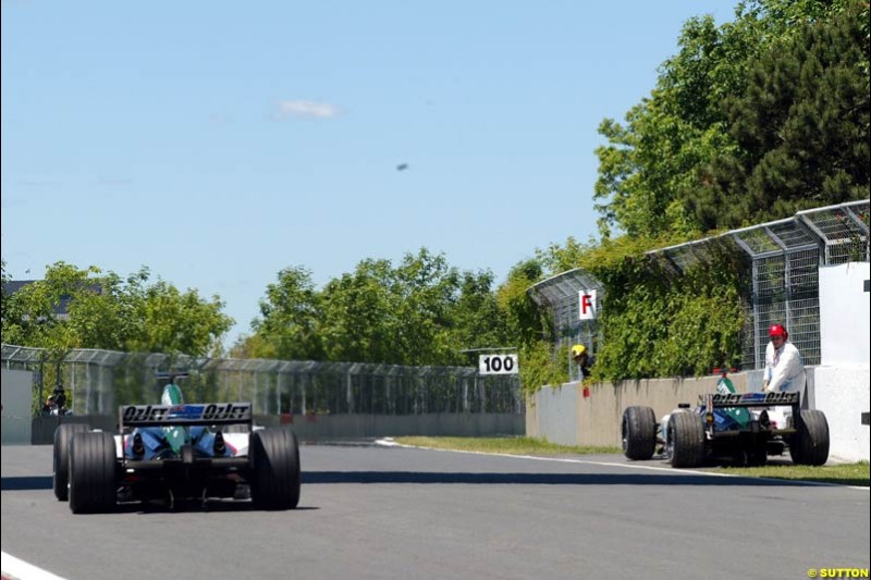 Zsolt Baumgartner, Minardi, drives by the stranded car of teammate Gianmaria Bruni. Qualifying for the Canadian Grand Prix. Montreal, Canada, 12 June 2004.