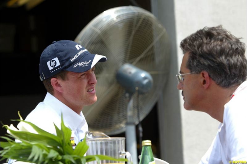Ralf Schumacher and BMW motorsport director Mario Theissen. United States GP, Indianapolis. June 17th, 2004.