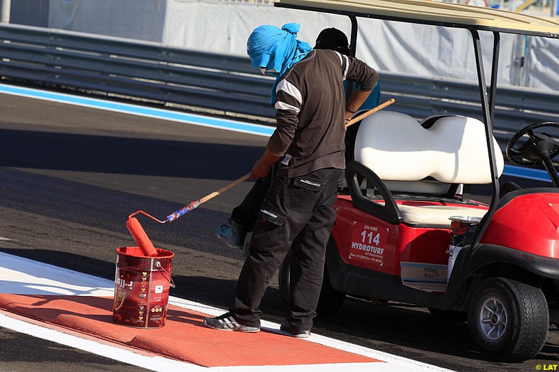 A circuit worker paints the track, Formula One World Championship, Round 18, Abu Dhabi Grand Prix, Yas Marina Circuit, United Arab Emirates. Thursday 1 November 2012.