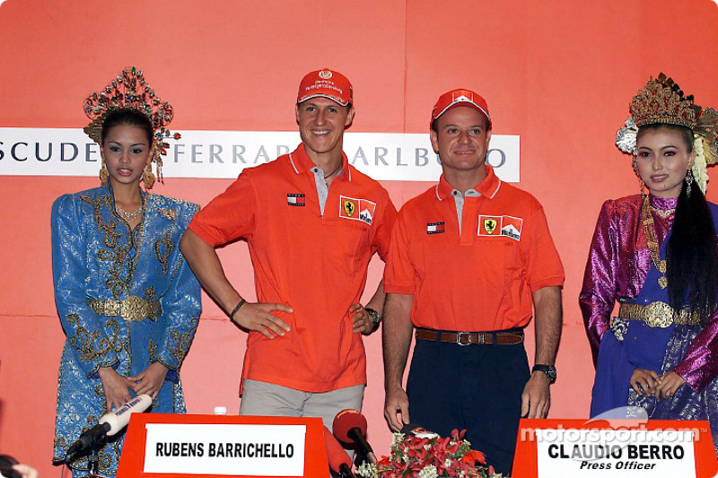 Michael Schumacher and Rubens Barrichello, with local beauties