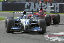 Juan Pablo Montoya in front of Michael Schumacher