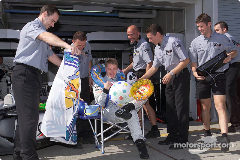 Team McLaren Mercedes presenting Mika Hakkinen some useful things for his break next year