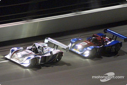 The #38 Porsche of Andy Wallace and Hurley Haywood races the #37 Judd Lola of Jon Field and Oliver Gavin through Daytona's banking